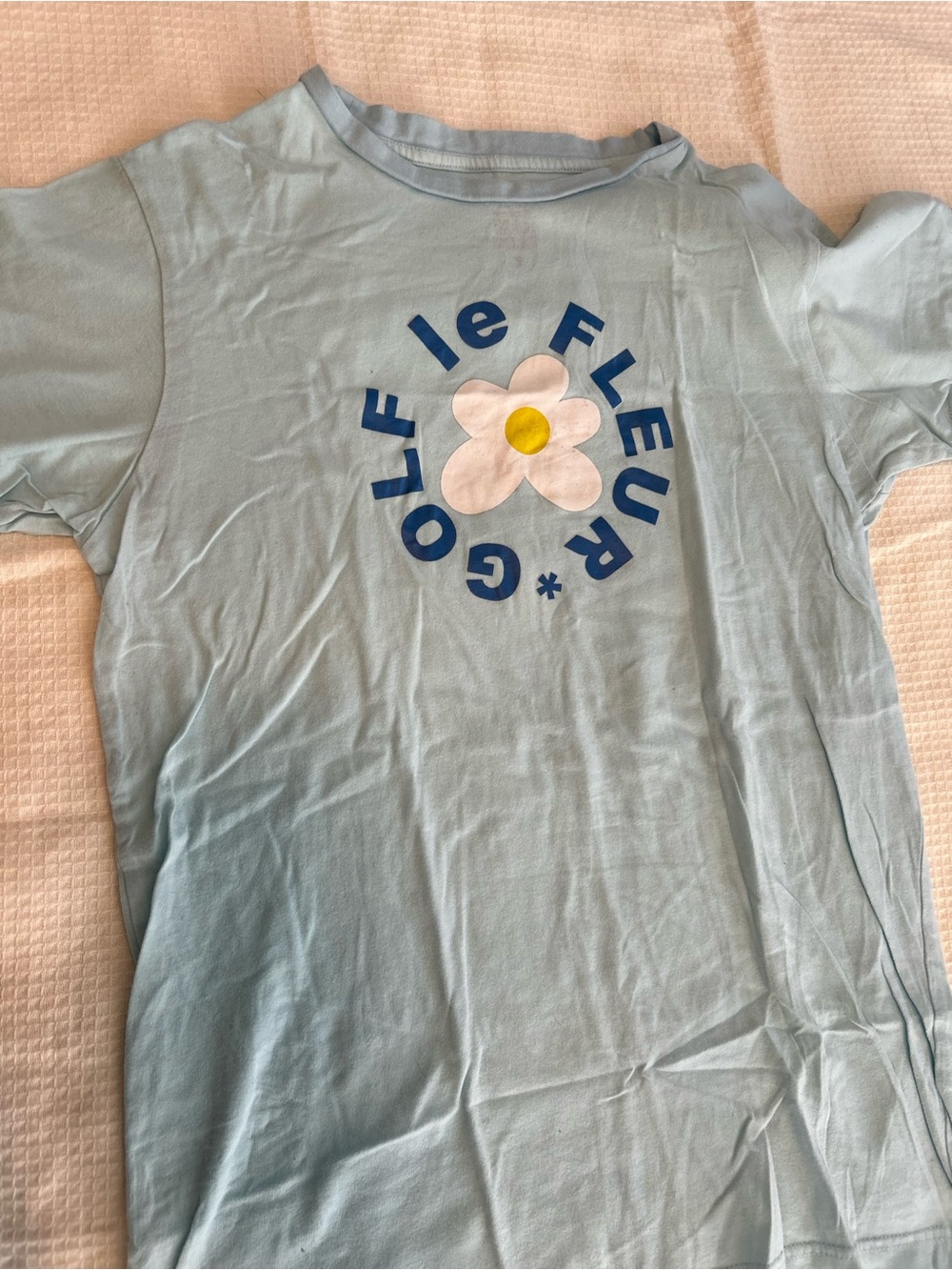 Golf Le Fleur Light Blue Tee with White Daisy Graphic